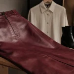 Jupe cuir bordeaux coupe droite nappa en studio, texture et coutures visibles