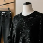 Pull paillette noir en maille brillante, coupe et texture visibles